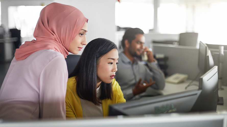 Colleagues working at computer