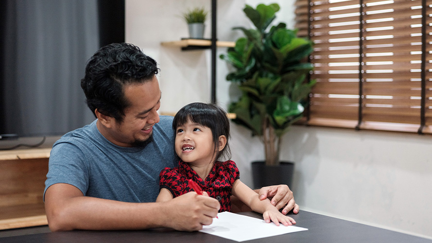 Man with daughter doing homework