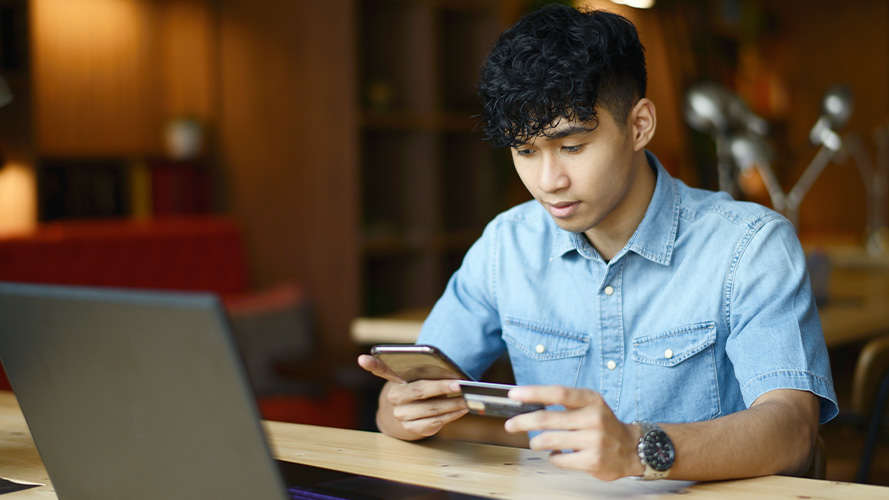 young man making payment on phone app