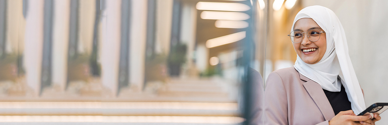 A woman talking on the phone; image used for HSBC Amanah Telebanking page.